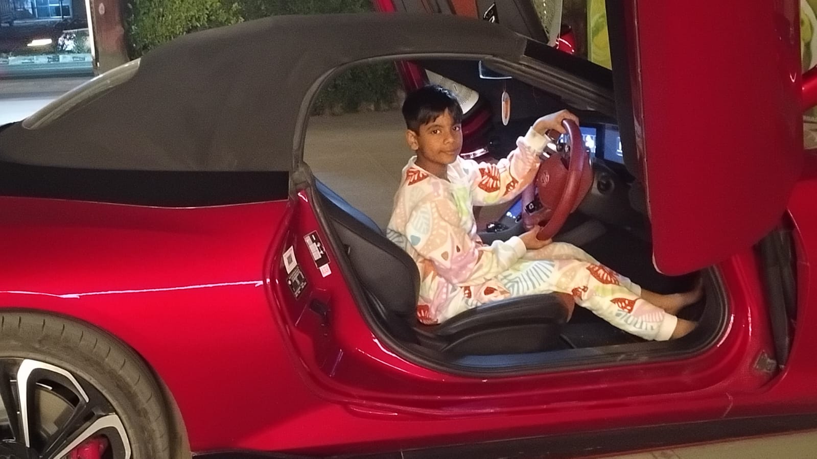 Manav in the red sports car